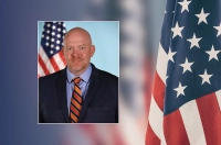 keynote speaker headshot with american flag