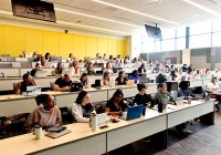 room full of students with laptops and water bottles