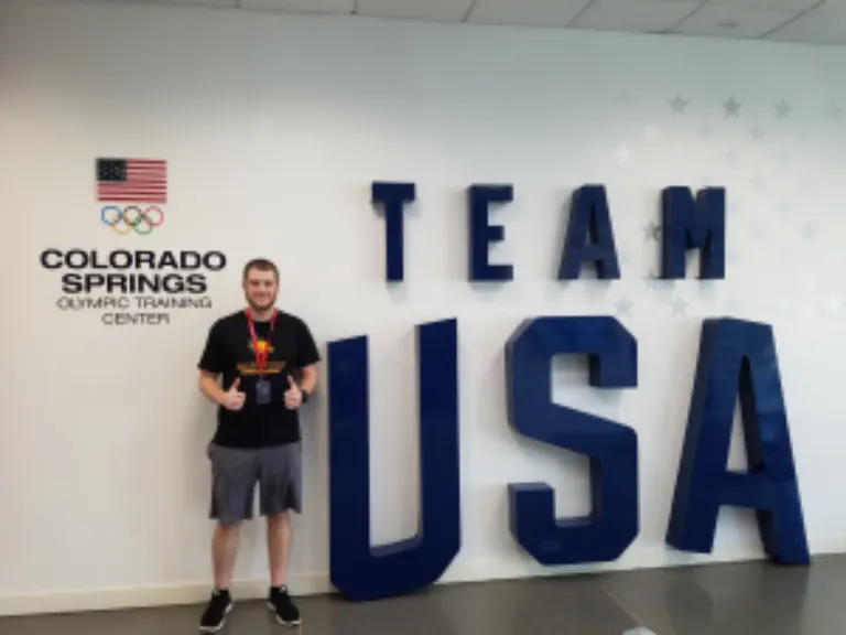 Nick Macano pictured next to a Team USA sign.