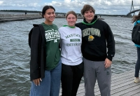 three marywood students with a body of water behind them