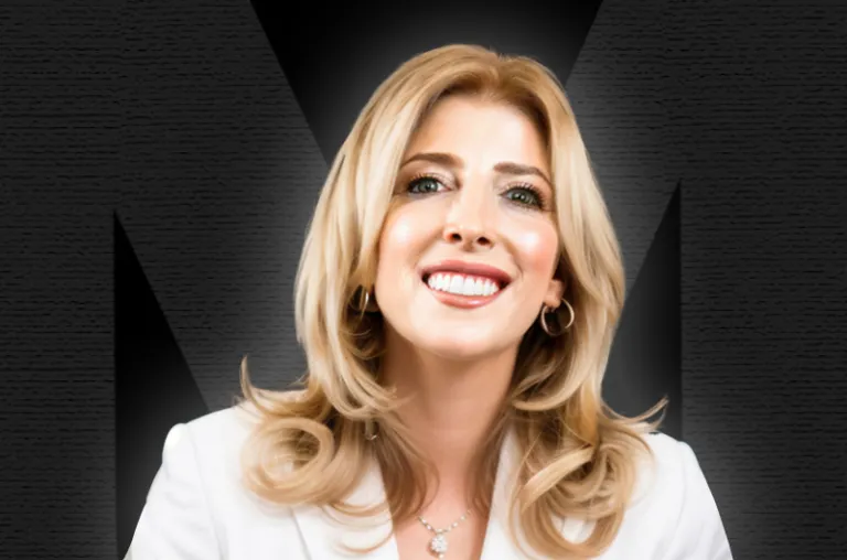 Blonde woman smiling, wearing a white suit agains a black background, with an M logo shaded in the background.