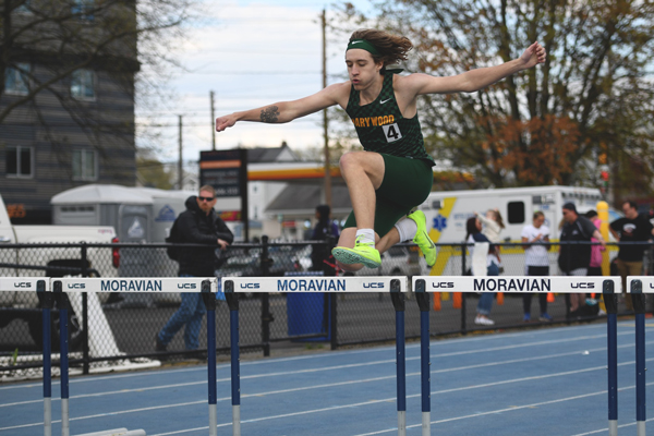 CJ Shygelski jumping over a hurdle