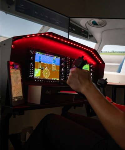 hands on flight controls inside airplane cockpit