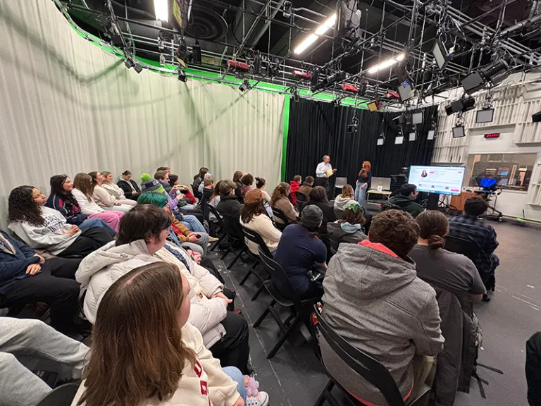 students in a room watching a screen