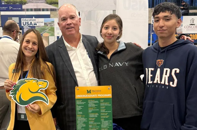 A woman and man with two adolescent students are pictured holding Marywood University branded materials, including a horse (Pacer) die-cut information card.