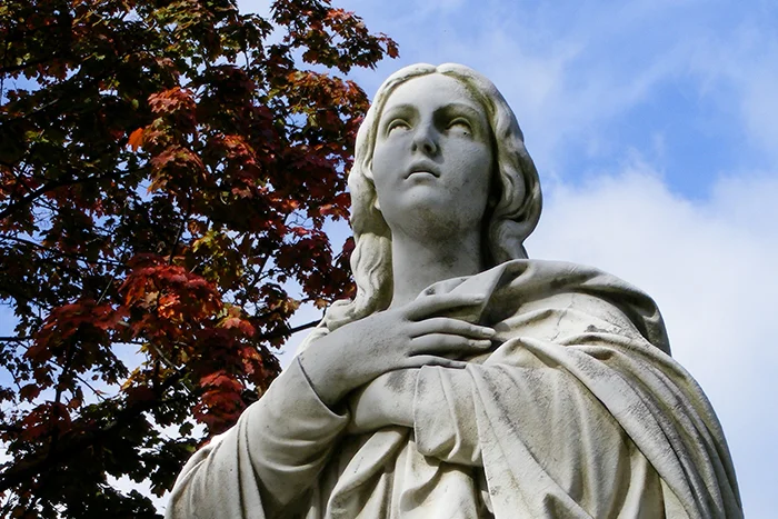A statue of Our Lady, in front of Assumption Hall