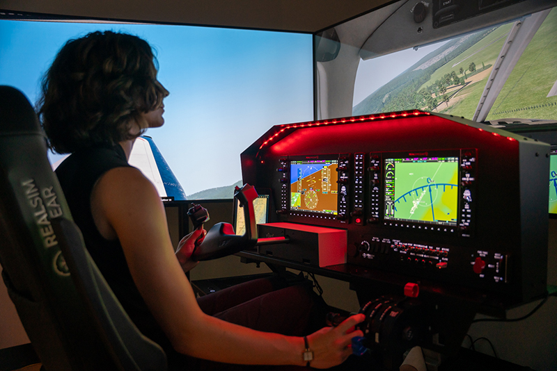 Woman using airplain simulator